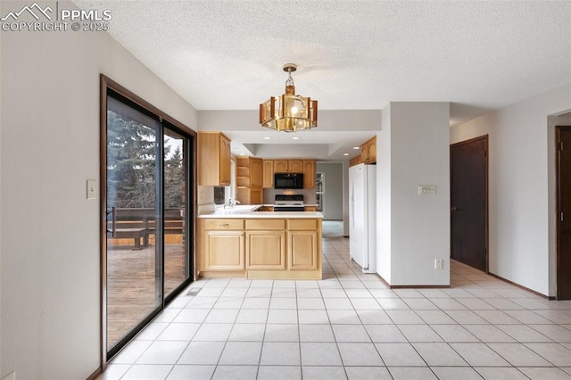 kitchen featuring black microwave, light tile patterned floors, a chandelier, range with electric stovetop, and freestanding refrigerator