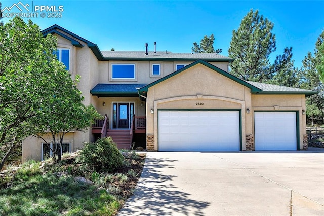 view of front facade featuring a garage, stone siding, concrete driveway, and stucco siding