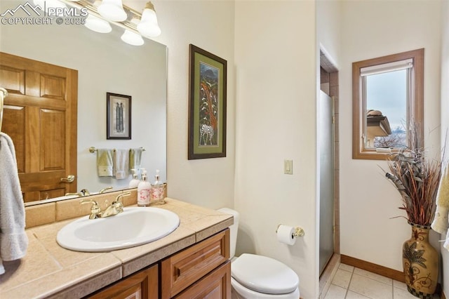 full bath with toilet, vanity, a chandelier, tile patterned flooring, and baseboards