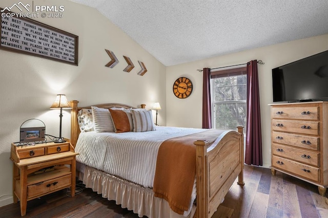 bedroom featuring a textured ceiling, dark wood-style flooring, and vaulted ceiling