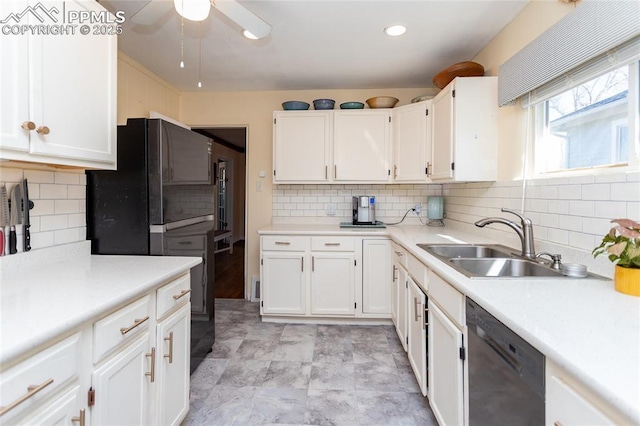 kitchen with white cabinetry, black appliances, light countertops, and a sink