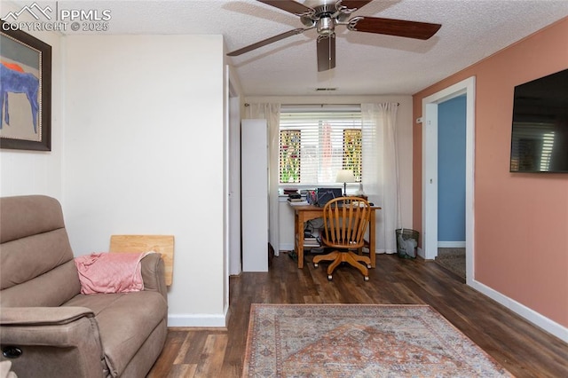 office area featuring ceiling fan, wood finished floors, baseboards, and a textured ceiling