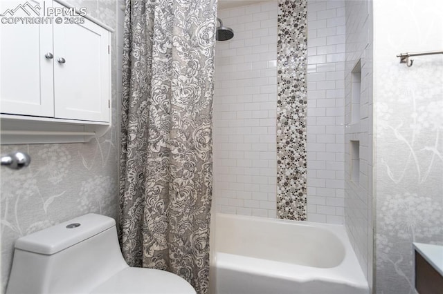 bathroom featuring toilet and shower / bath combination with curtain