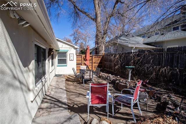 view of patio / terrace featuring fence