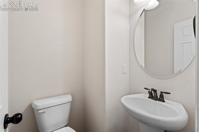 bathroom featuring toilet and a sink