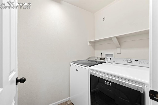 laundry area with tile patterned flooring, laundry area, independent washer and dryer, and baseboards