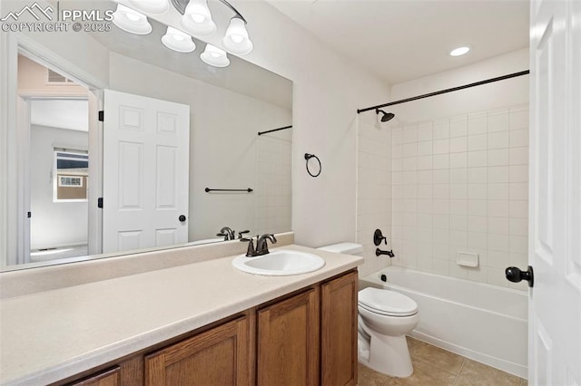 full bath featuring toilet, visible vents, vanity, tile patterned floors, and washtub / shower combination