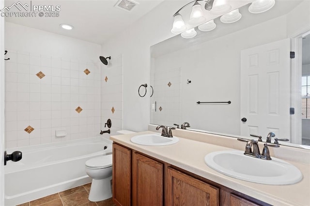 bathroom featuring shower / washtub combination, visible vents, a sink, and toilet