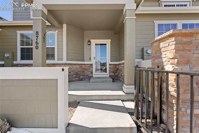 property entrance with stone siding