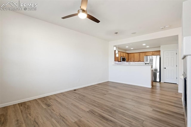 unfurnished living room with light wood-style flooring, baseboards, ceiling fan, and recessed lighting