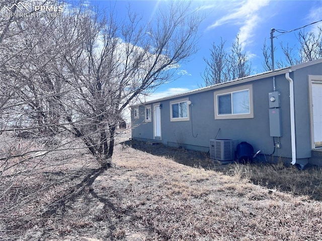 view of home's exterior featuring central air condition unit and stucco siding