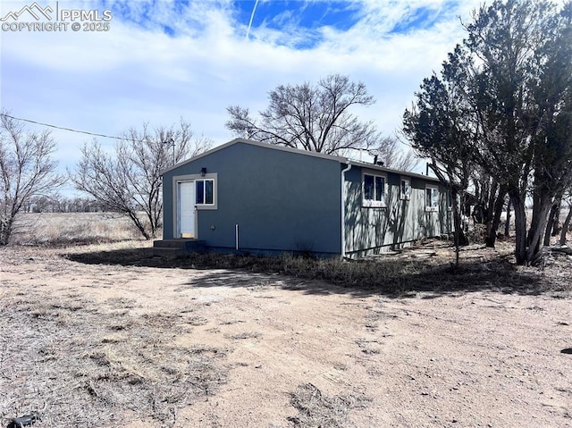 view of side of property with stucco siding