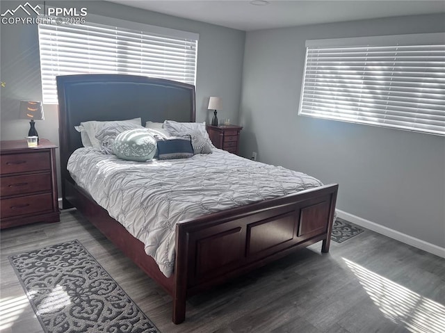 bedroom featuring baseboards and wood finished floors