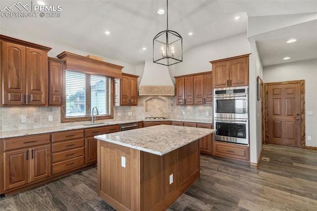 17820 Pioneer Xing, Colorado Springs, CO 80908 - kitchen with stainless steel appliances, a sink, custom range hood, a center island, and recessed lighting
