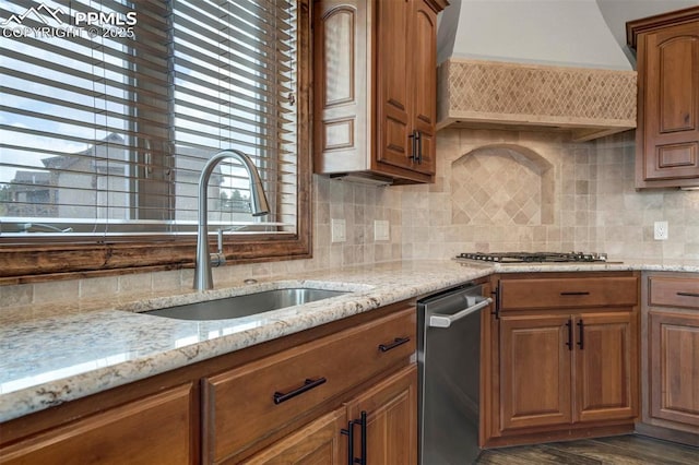 17820 Pioneer Xing, Colorado Springs, CO 80908 - kitchen featuring a sink, custom range hood, appliances with stainless steel finishes, tasteful backsplash, and brown cabinetry