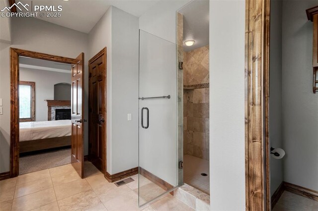 17820 Pioneer Xing, Colorado Springs, CO 80908 - full bath featuring baseboards, ensuite bath, a shower stall, and a glass covered fireplace