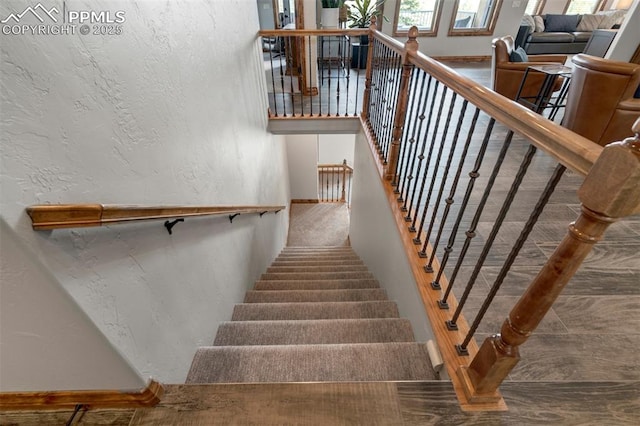 17820 Pioneer Xing, Colorado Springs, CO 80908 - stairs featuring a textured wall and baseboards