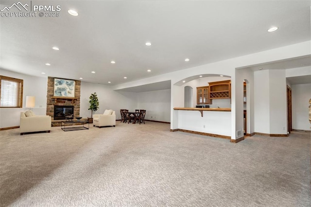17820 Pioneer Xing, Colorado Springs, CO 80908 - living area with a stone fireplace, carpet, recessed lighting, and baseboards