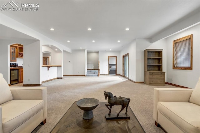 17820 Pioneer Xing, Colorado Springs, CO 80908 - living area with light carpet, baseboards, recessed lighting, and arched walkways