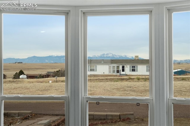 doorway to outside with a wealth of natural light and a mountain view