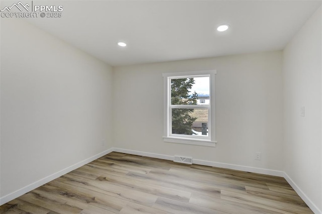 unfurnished room with visible vents, recessed lighting, light wood-style floors, and baseboards