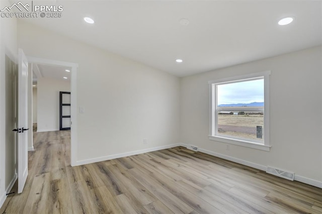 spare room with baseboards, recessed lighting, visible vents, and light wood-type flooring