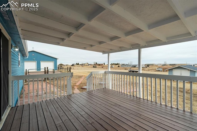 wooden deck with an outbuilding and a rural view