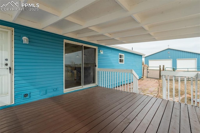 wooden terrace featuring an outbuilding