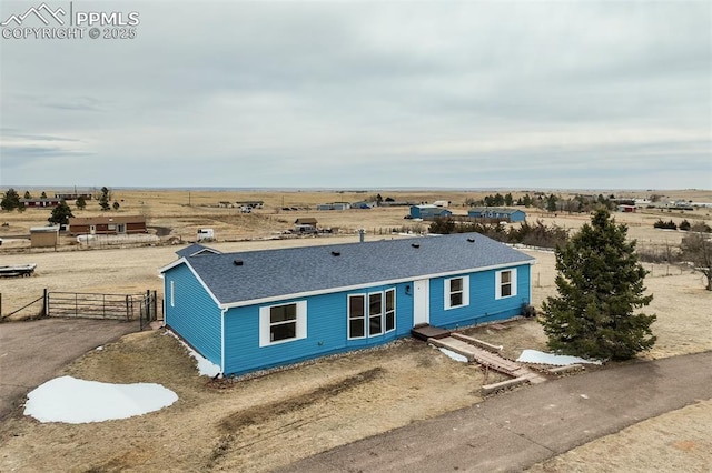 single story home featuring a gate, a shingled roof, driveway, and fence