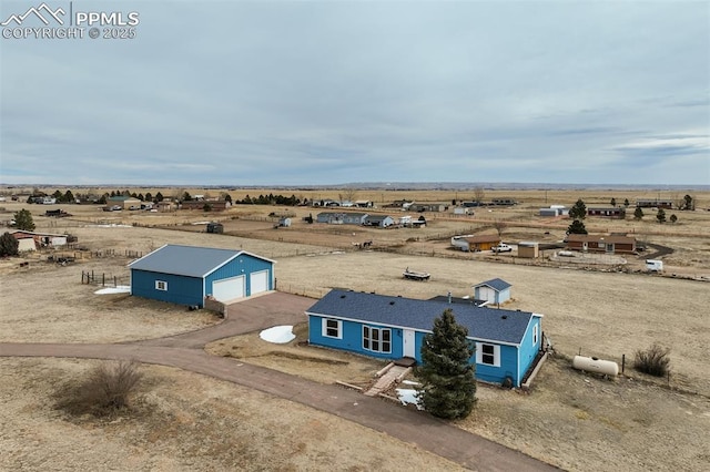 birds eye view of property with a rural view