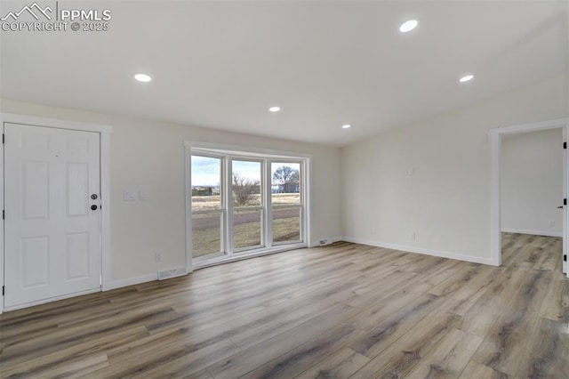 unfurnished living room with recessed lighting, visible vents, and light wood-style flooring