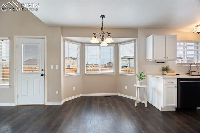 kitchen featuring dishwasher, light countertops, dark wood finished floors, and white cabinetry