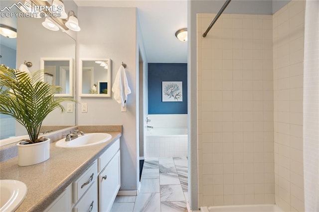 bathroom featuring marble finish floor, a garden tub, double vanity, a sink, and tiled shower