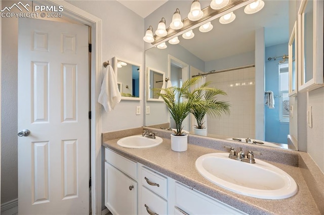 full bath with double vanity, a shower, and a sink