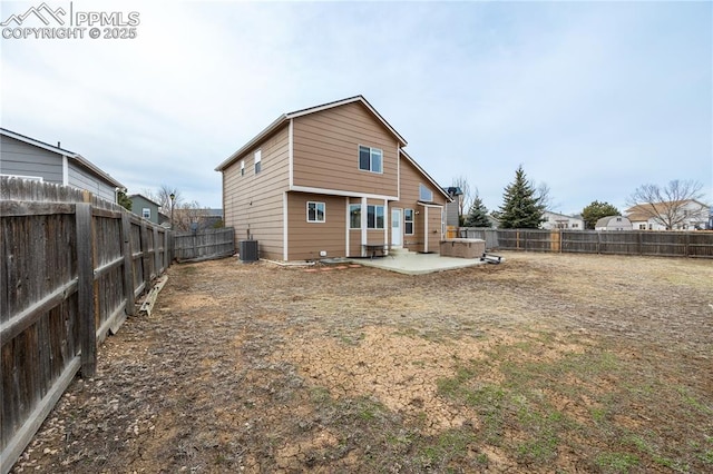 rear view of house with a patio area, a fenced backyard, and central air condition unit