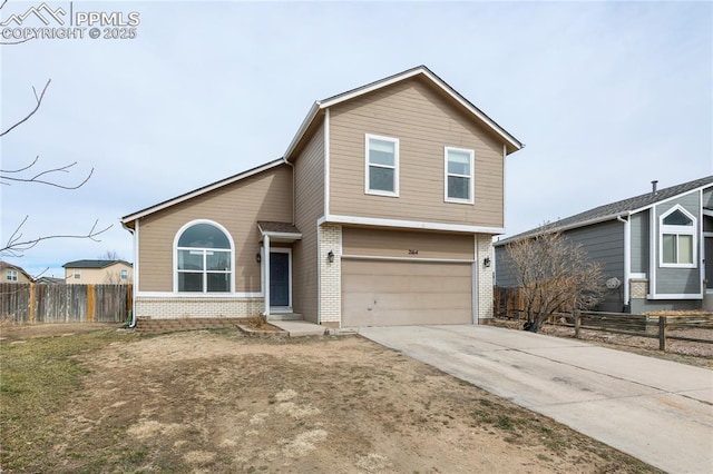 view of front of home featuring driveway, brick siding, an attached garage, and fence