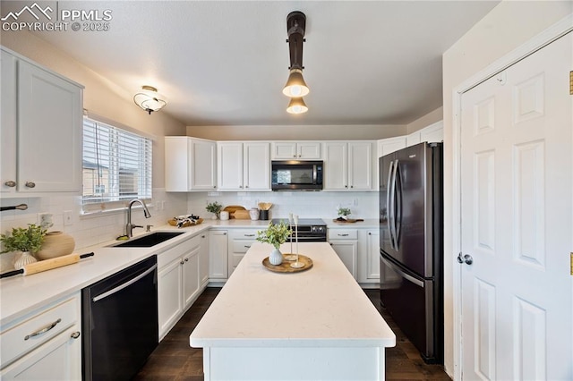 kitchen with decorative backsplash, freestanding refrigerator, dishwasher, and a sink