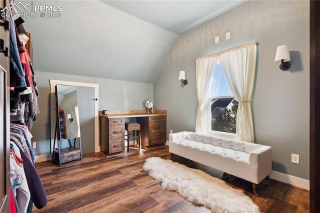 bedroom with baseboards, vaulted ceiling, and dark wood finished floors