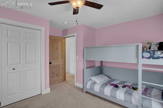 carpeted bedroom featuring ceiling fan, a closet, and baseboards