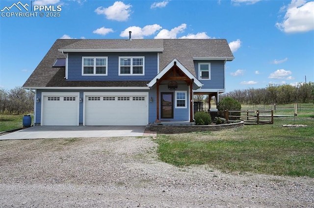 view of front facade with a front lawn, gravel driveway, fence, and a shingled roof