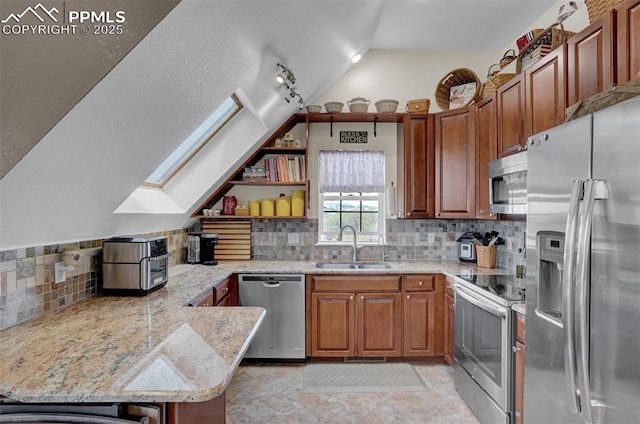 kitchen featuring lofted ceiling with skylight, a peninsula, stainless steel appliances, open shelves, and a sink