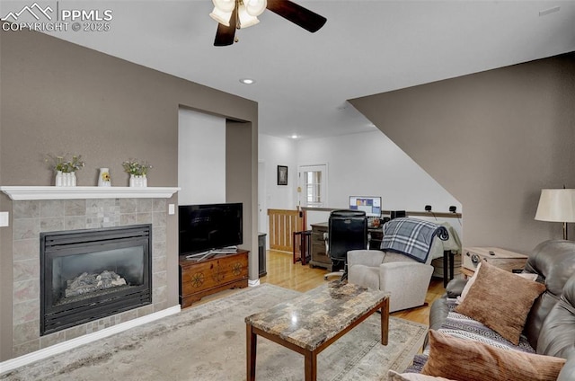 living room featuring a fireplace, wood finished floors, a ceiling fan, and recessed lighting