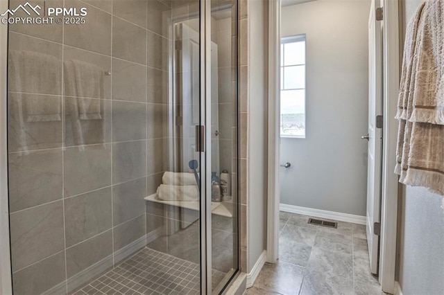 full bathroom featuring baseboards, visible vents, and a stall shower