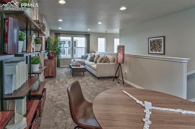 carpeted living room with recessed lighting and baseboards