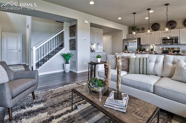 living area with visible vents, dark wood-style floors, recessed lighting, baseboards, and stairs