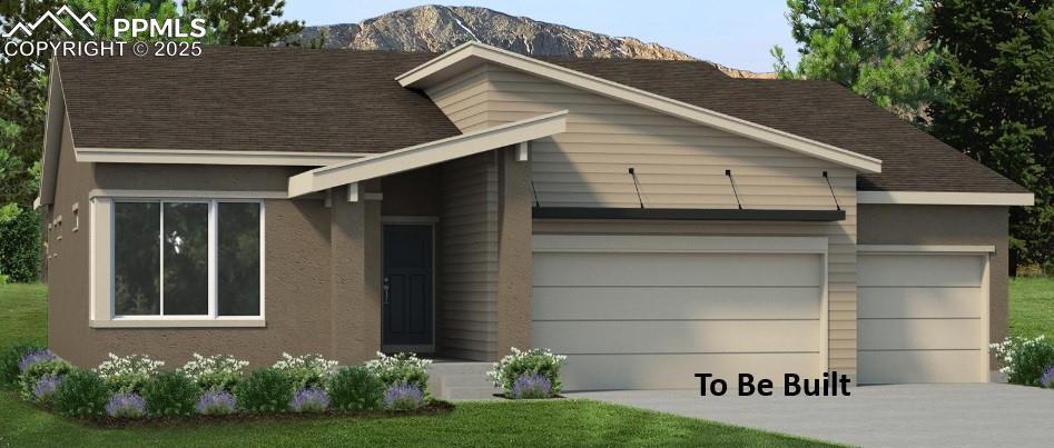 view of front of house with driveway, an attached garage, a mountain view, and stucco siding