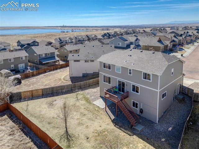 aerial view featuring a residential view and a water view