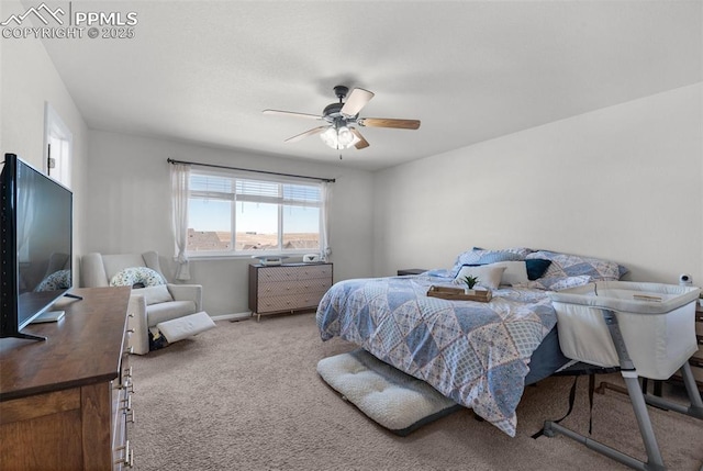 carpeted bedroom featuring a ceiling fan and baseboards