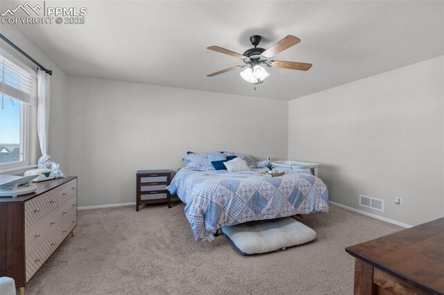 bedroom with a ceiling fan, light colored carpet, visible vents, and baseboards