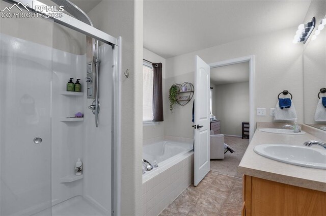 full bath with double vanity, a stall shower, a sink, and a bath